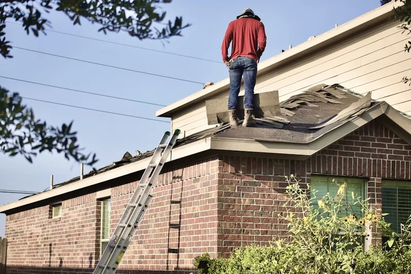 Professional roofer working on a residential roof in Hyde Field Estates